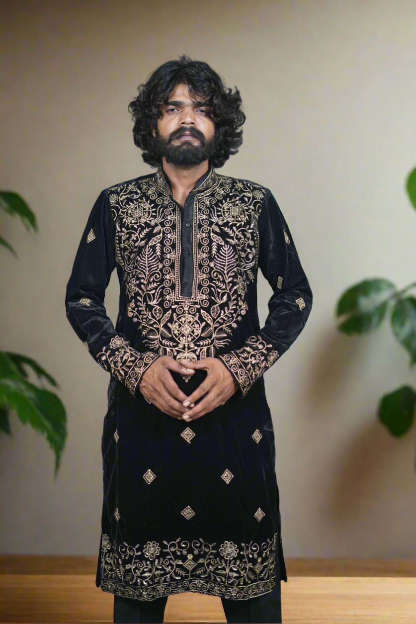 Men's black kurta set with intricate golden embroidery, paired with matching trousers, perfect for festive occasions."