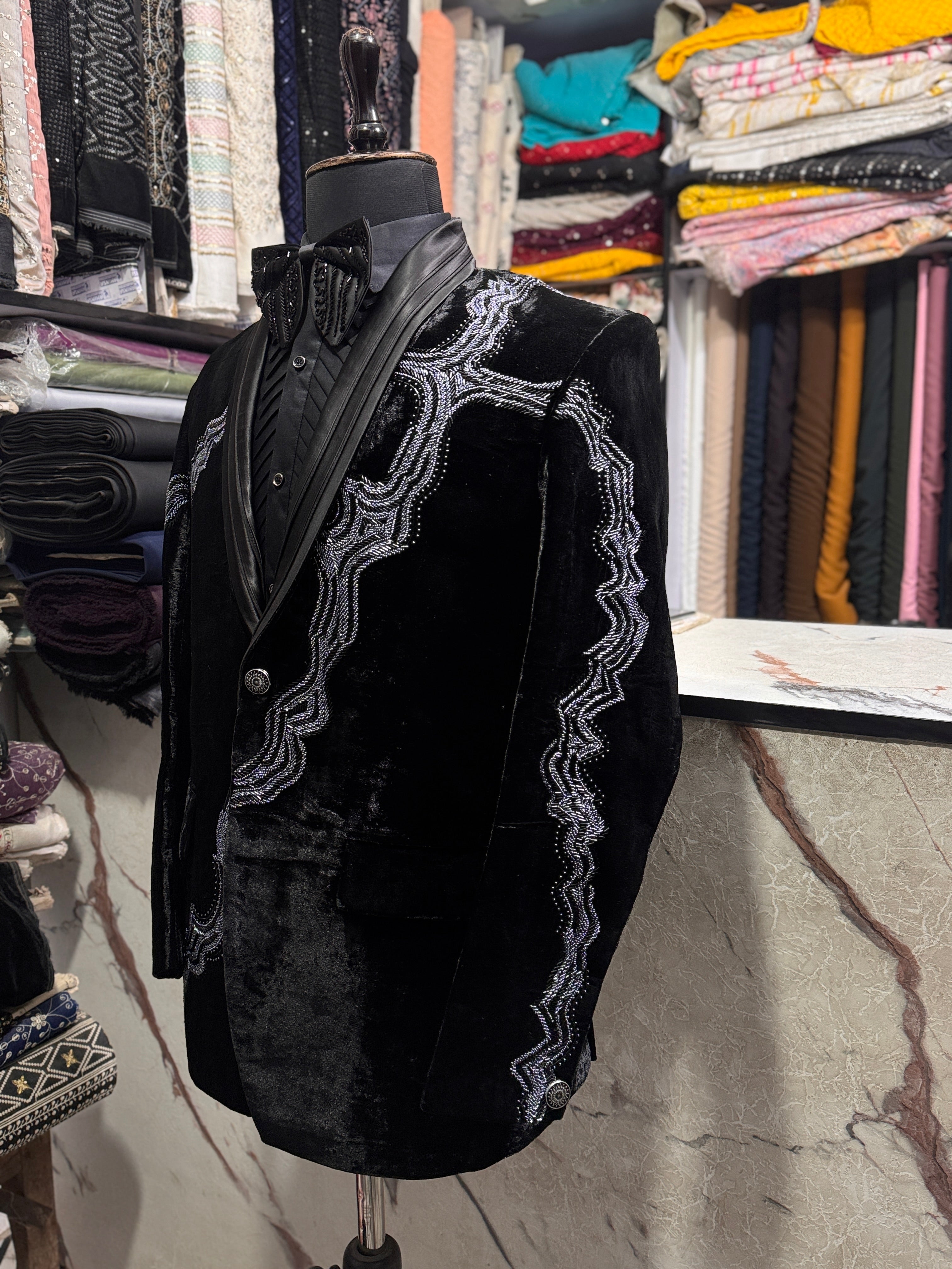 A model in a black formal suit, designed to make a statement at any special occasion.

