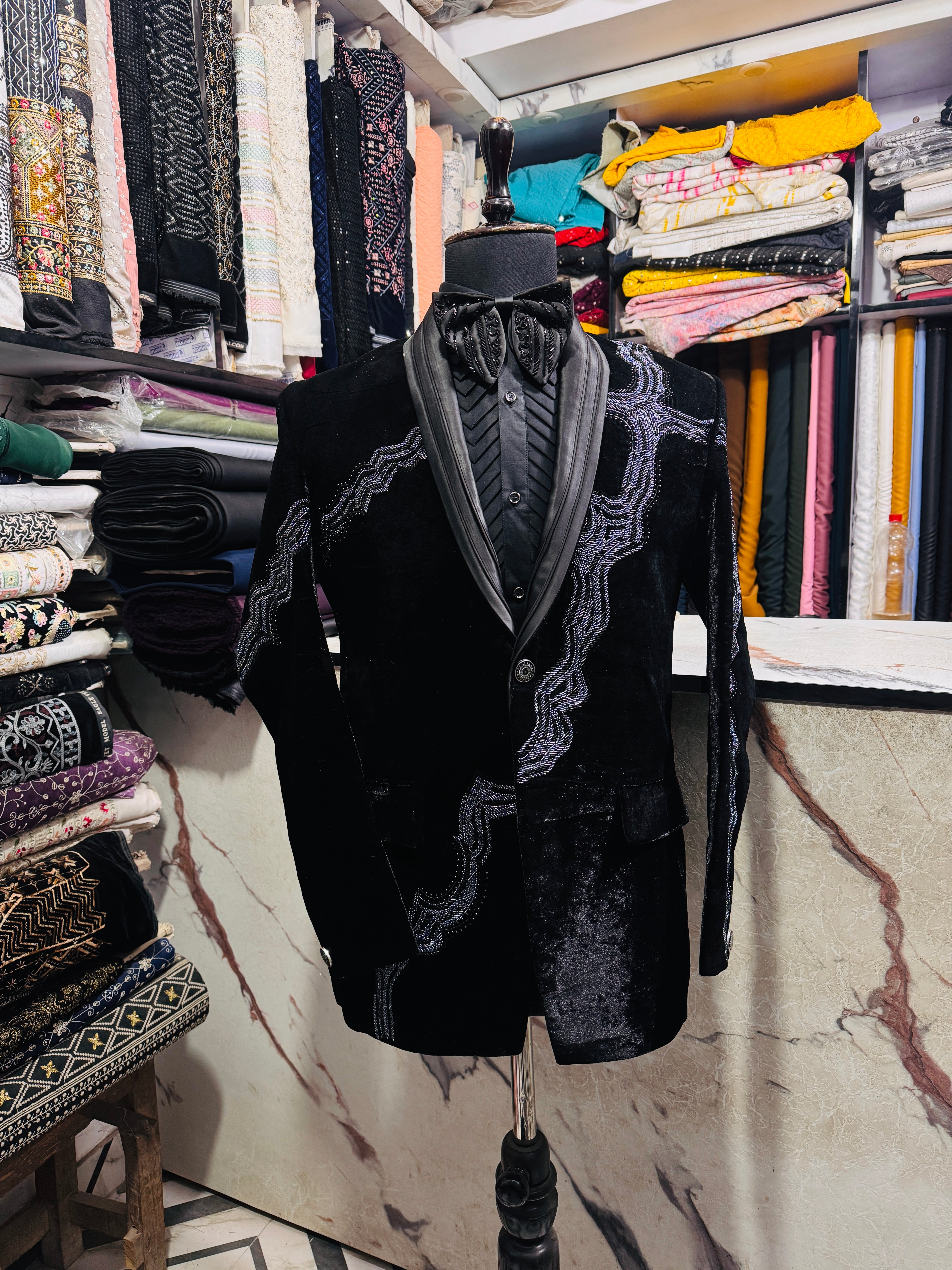 A photograph of a man in a stylish tuxedo, emphasizing the quality of the velvet fabric and the overall craftsmanship.

