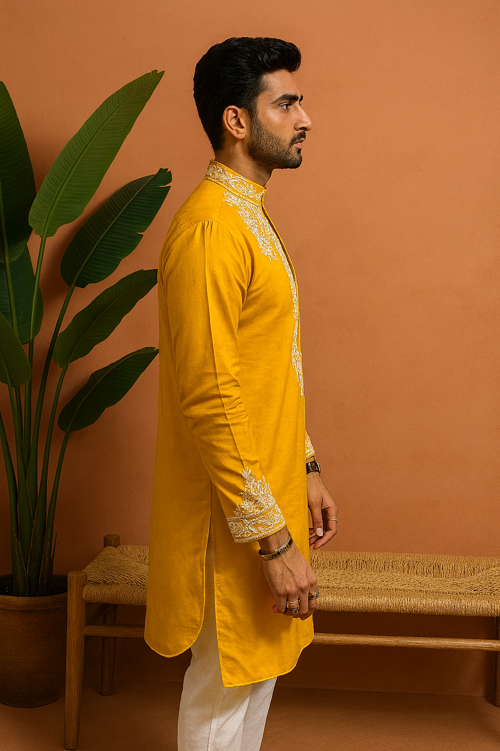A rear view of the man in the yellow kurta, highlighting the clean, simple design from the back.

