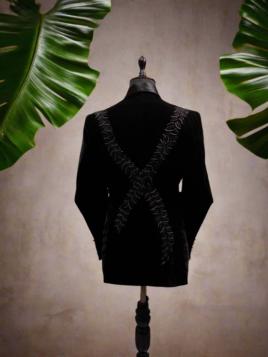 A photograph of a man in a stylish tuxedo, emphasizing the quality of the velvet fabric and the overall craftsmanship.

