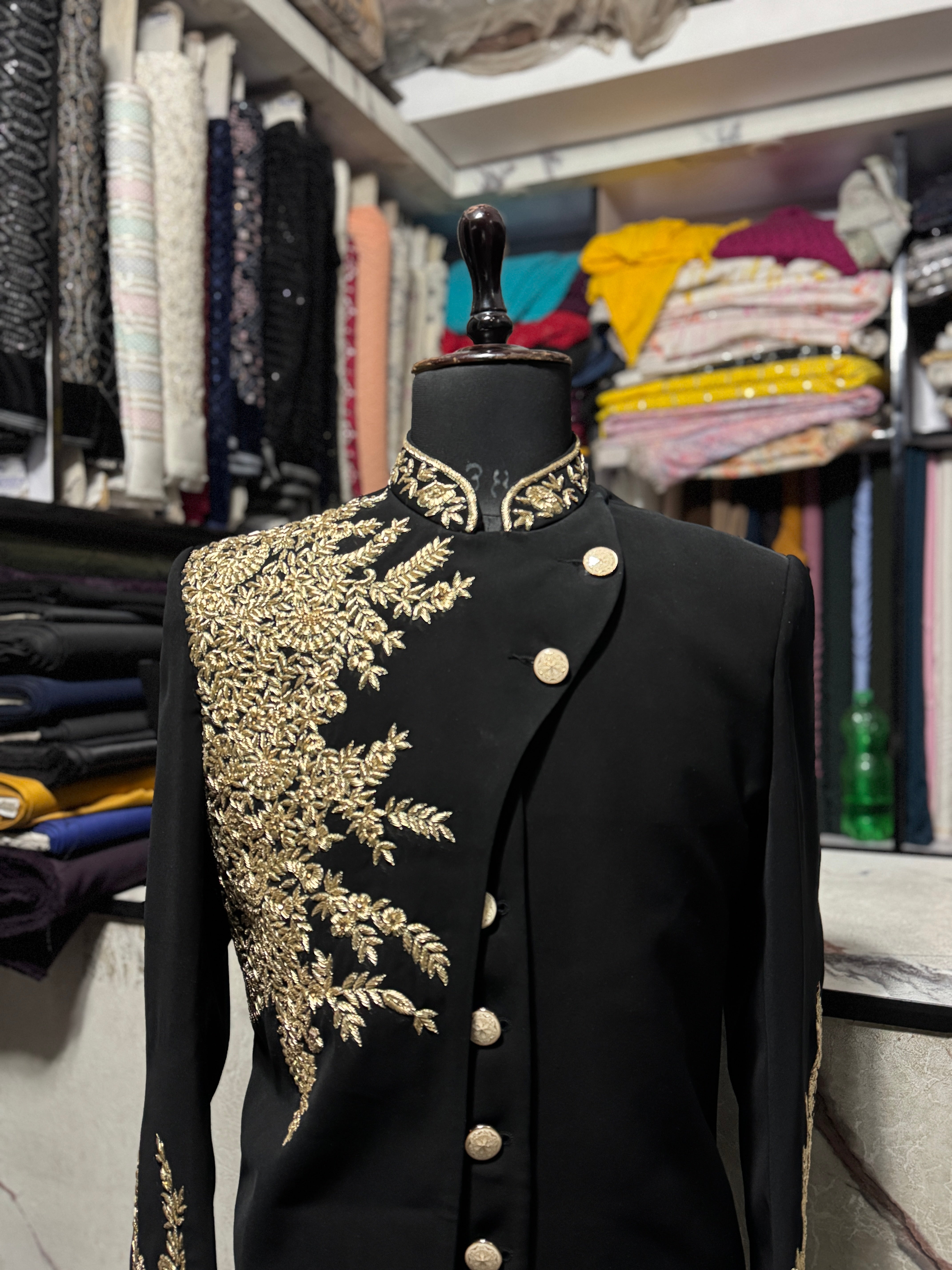 Designer black groom sherwani with asymmetrical cut and gold buttons – KPH Outfits