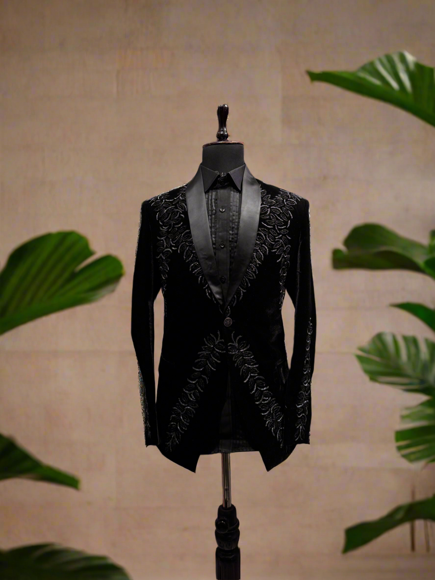 A photograph of a man in a stylish tuxedo, emphasizing the quality of the velvet fabric and the overall craftsmanship.

