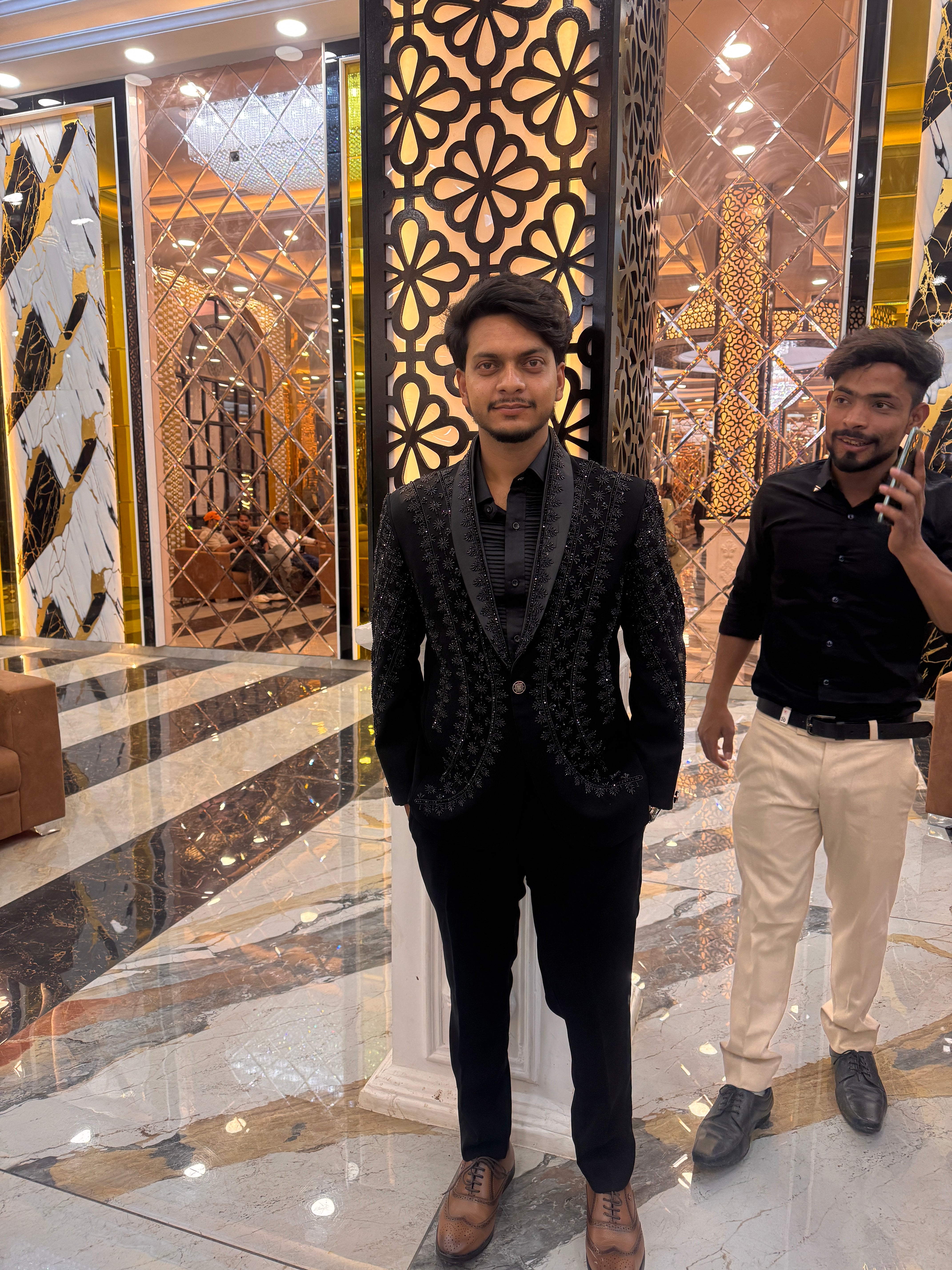 A full-body shot of the man standing in the tuxedo, emphasizing the fit of the suit and the details of the hand-painted art.

