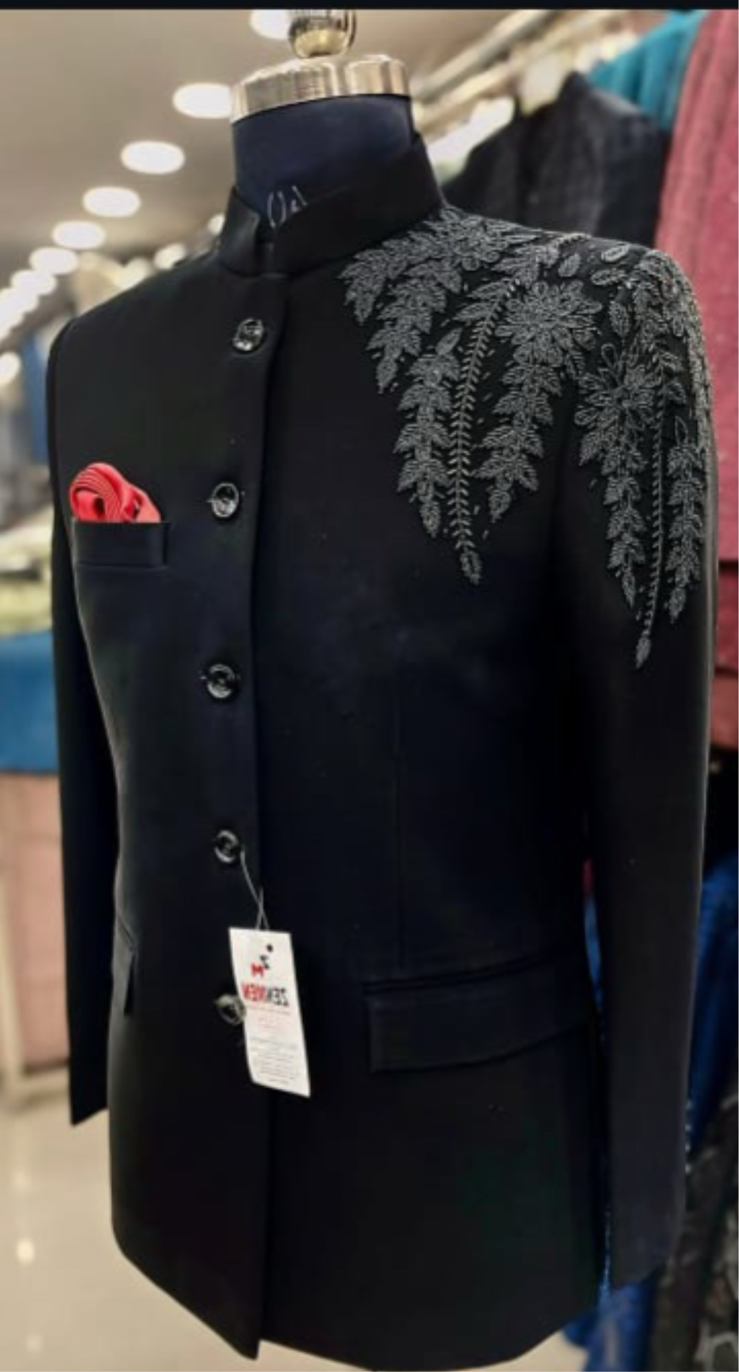 A man sitting on a chair, showcasing the comfort and style of the Jodhpuri set.

