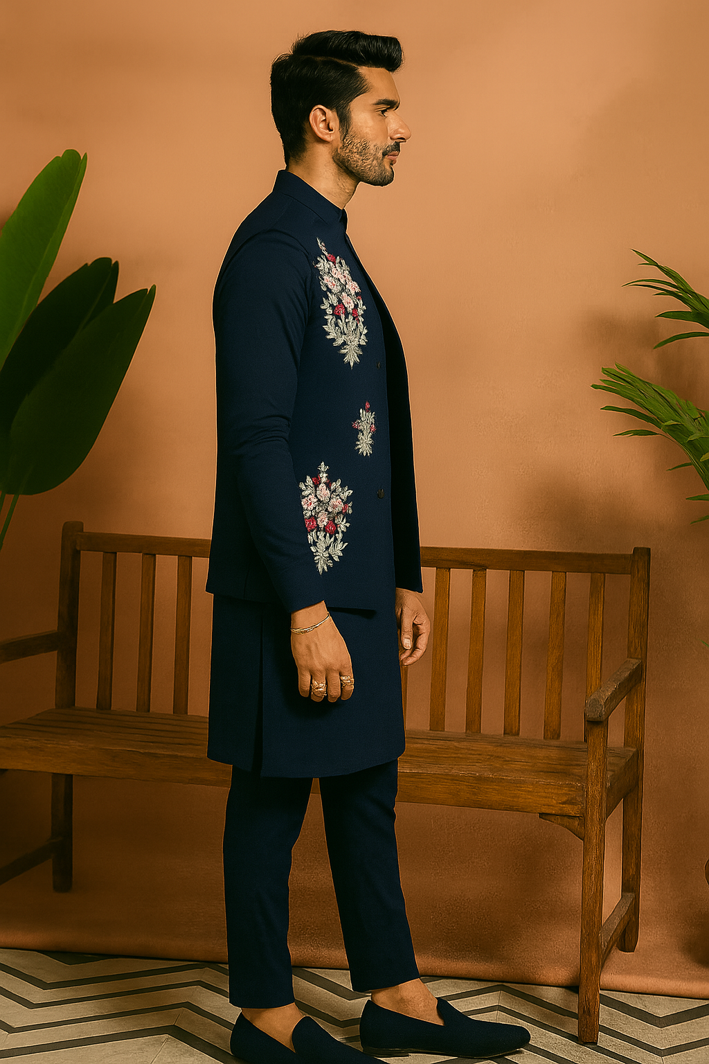 A man wearing an elegant navy blue kurta set with an intricately embellished Nehru jacket, suitable for a Sangeet night.