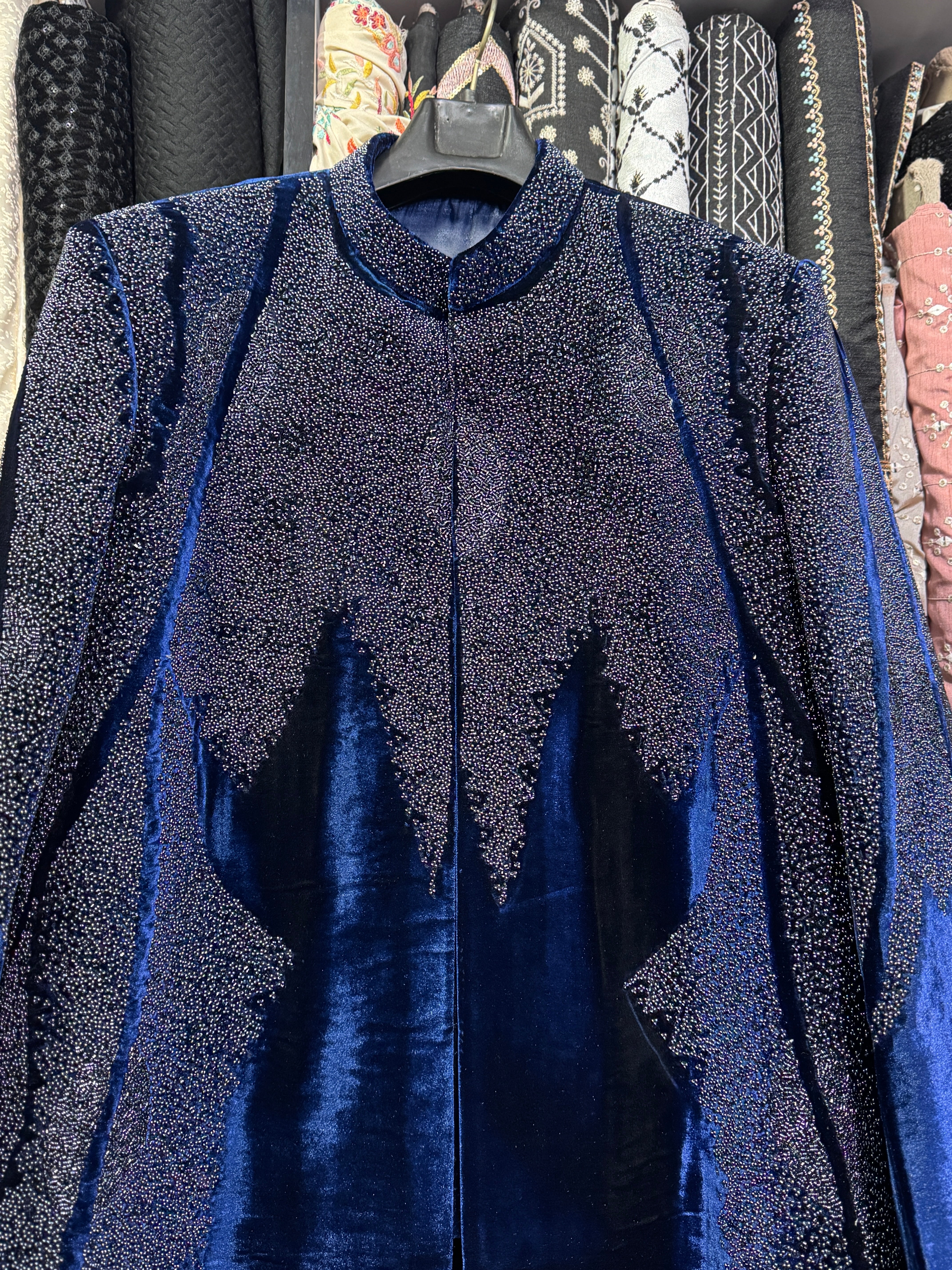 Close-up of handcrafted beadwork on velvet sherwani