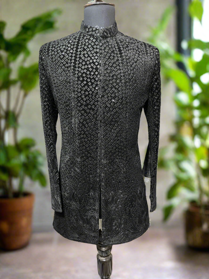 Close-up of intricate embroidery on a black designer Indo-western set.
