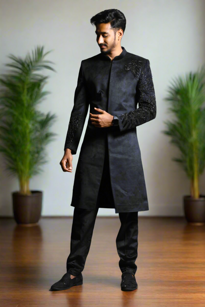 Close-up of intricate embroidery on black sherwani.
