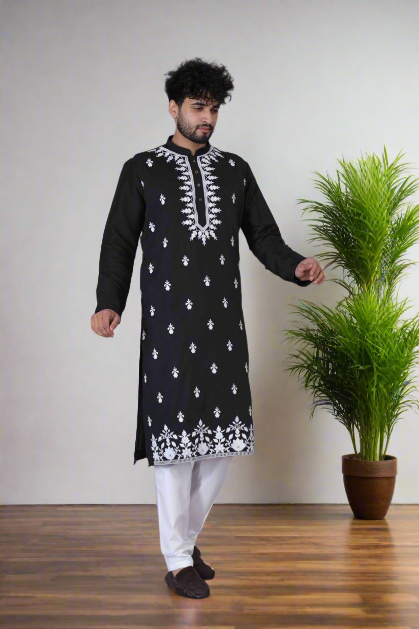 Close-up of embroidered patterns on black kurta.