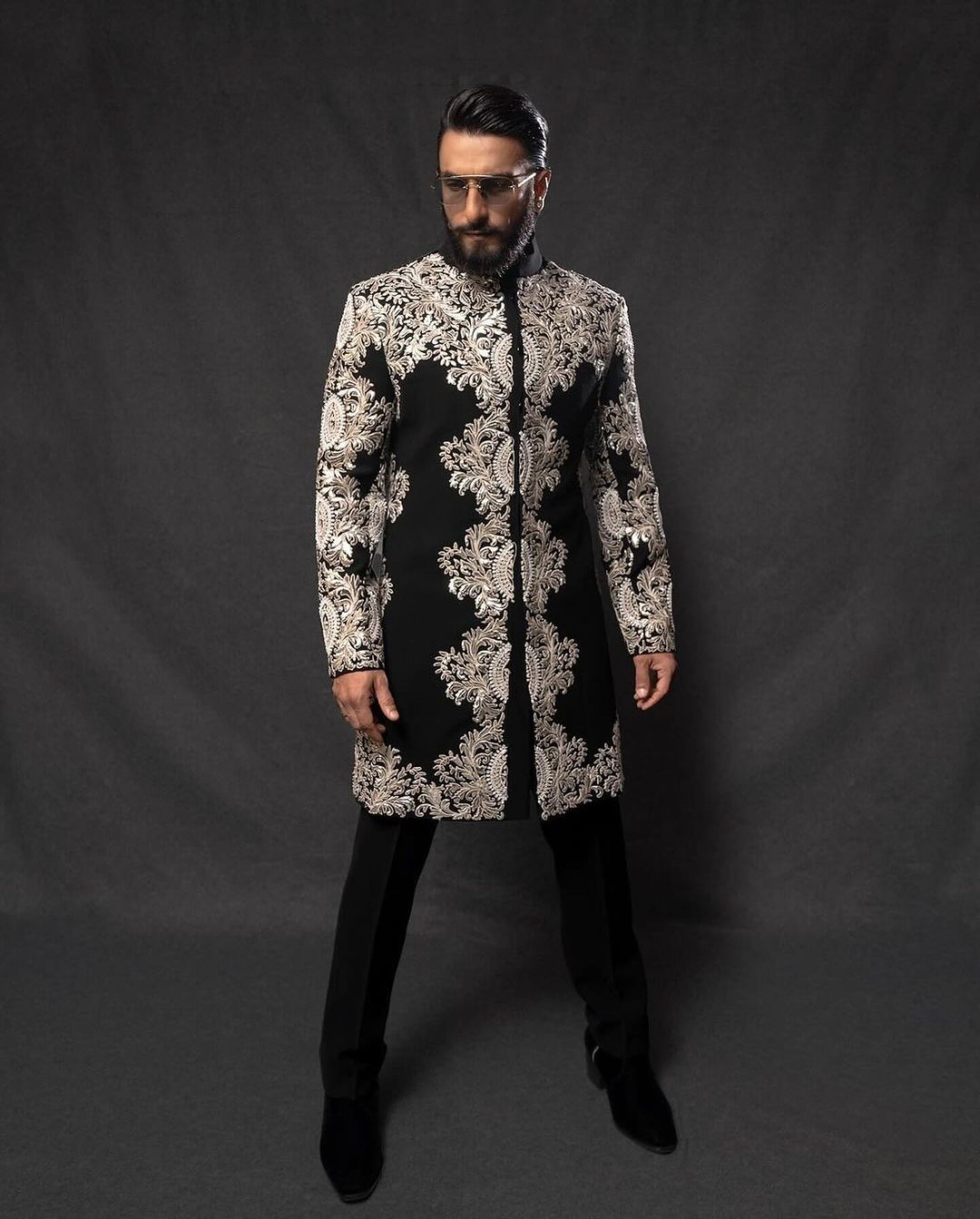 "Designer men’s black sherwani inspired by Bollywood fashion"
