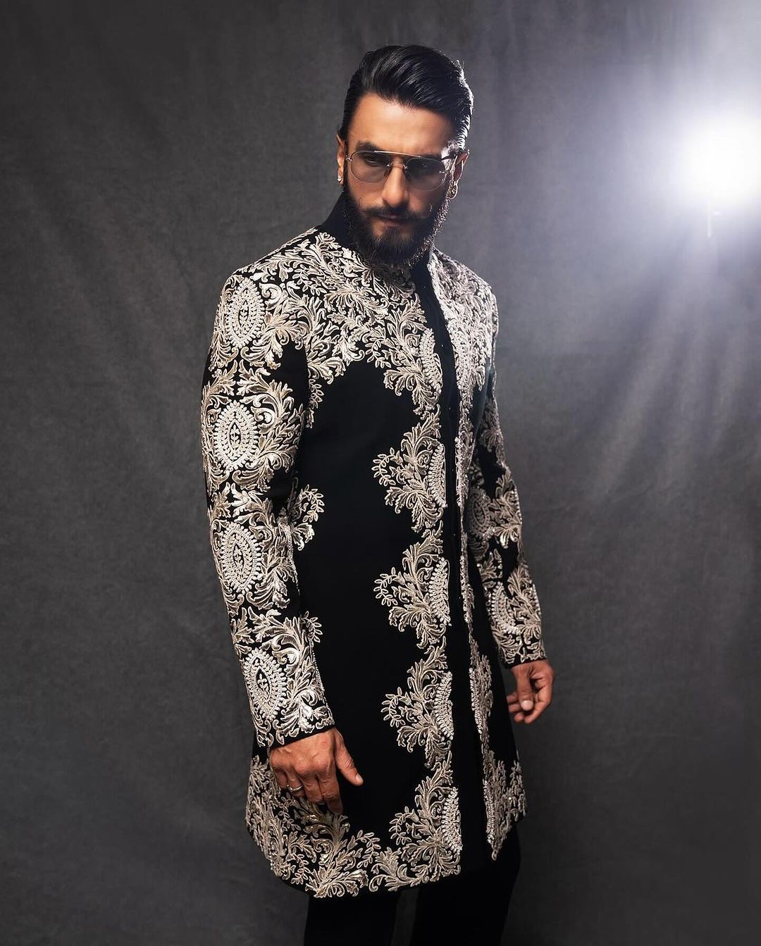 "Elegant black sherwani set for men with intricate detailing"
