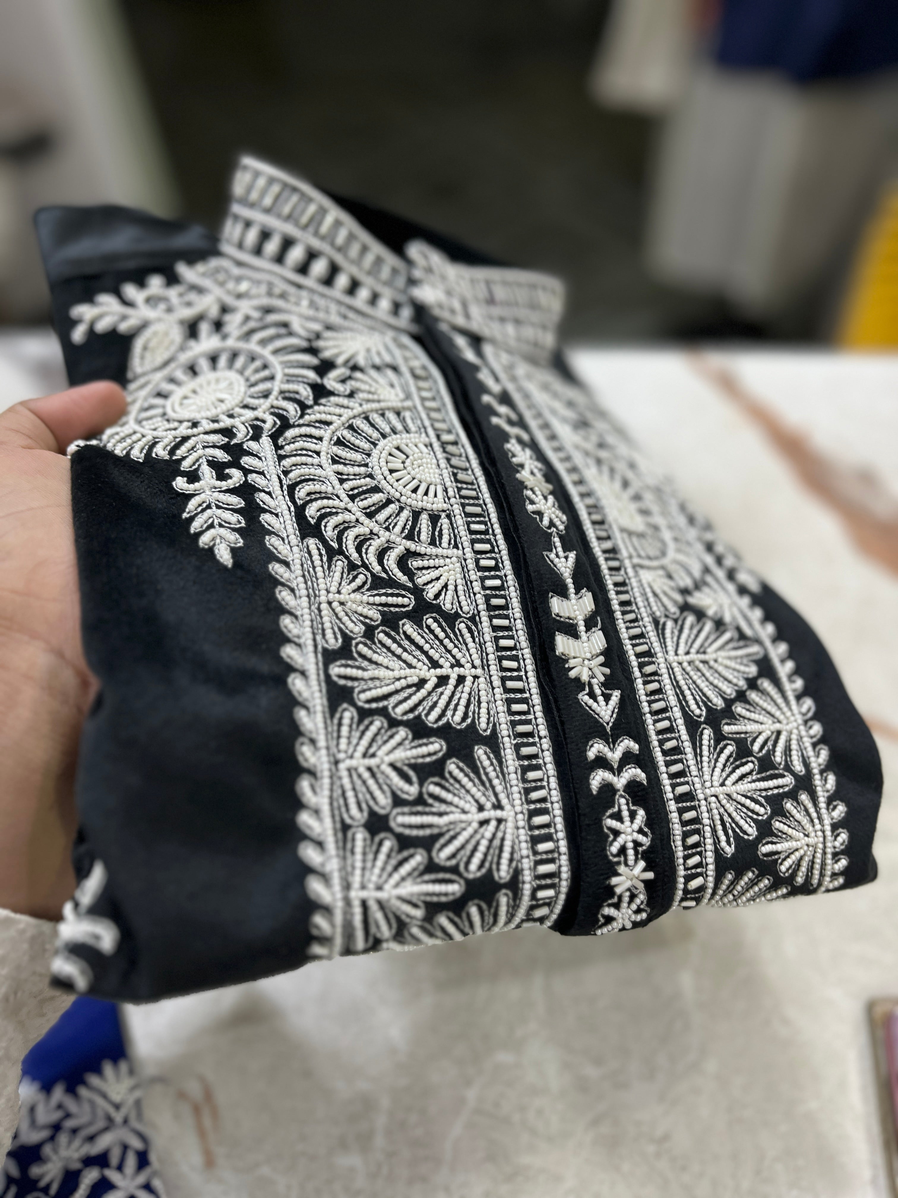 Elegant men's kurta set with handcrafted beads and velvet fabric.
