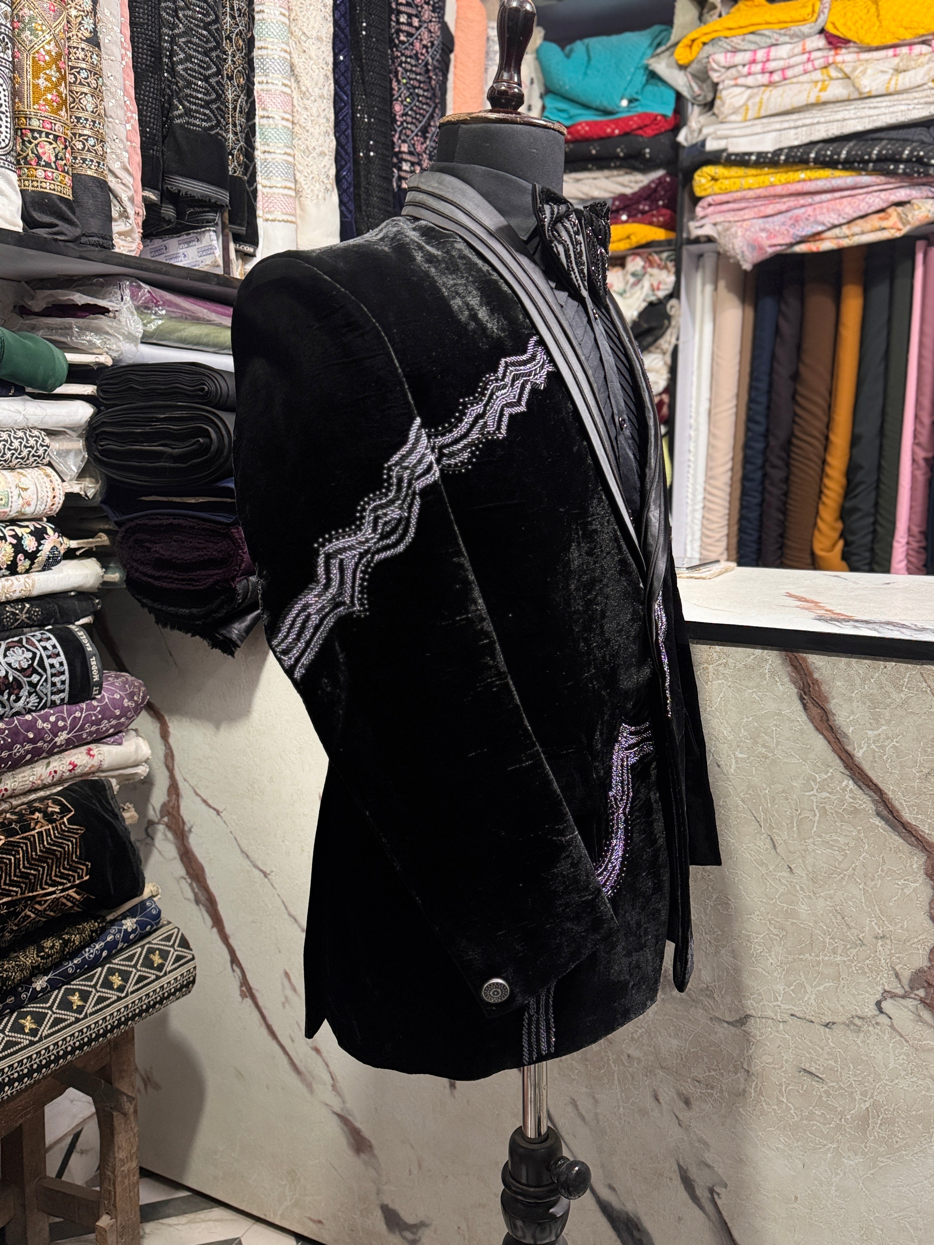 A model in a black formal suit, designed to make a statement at any special occasion.

