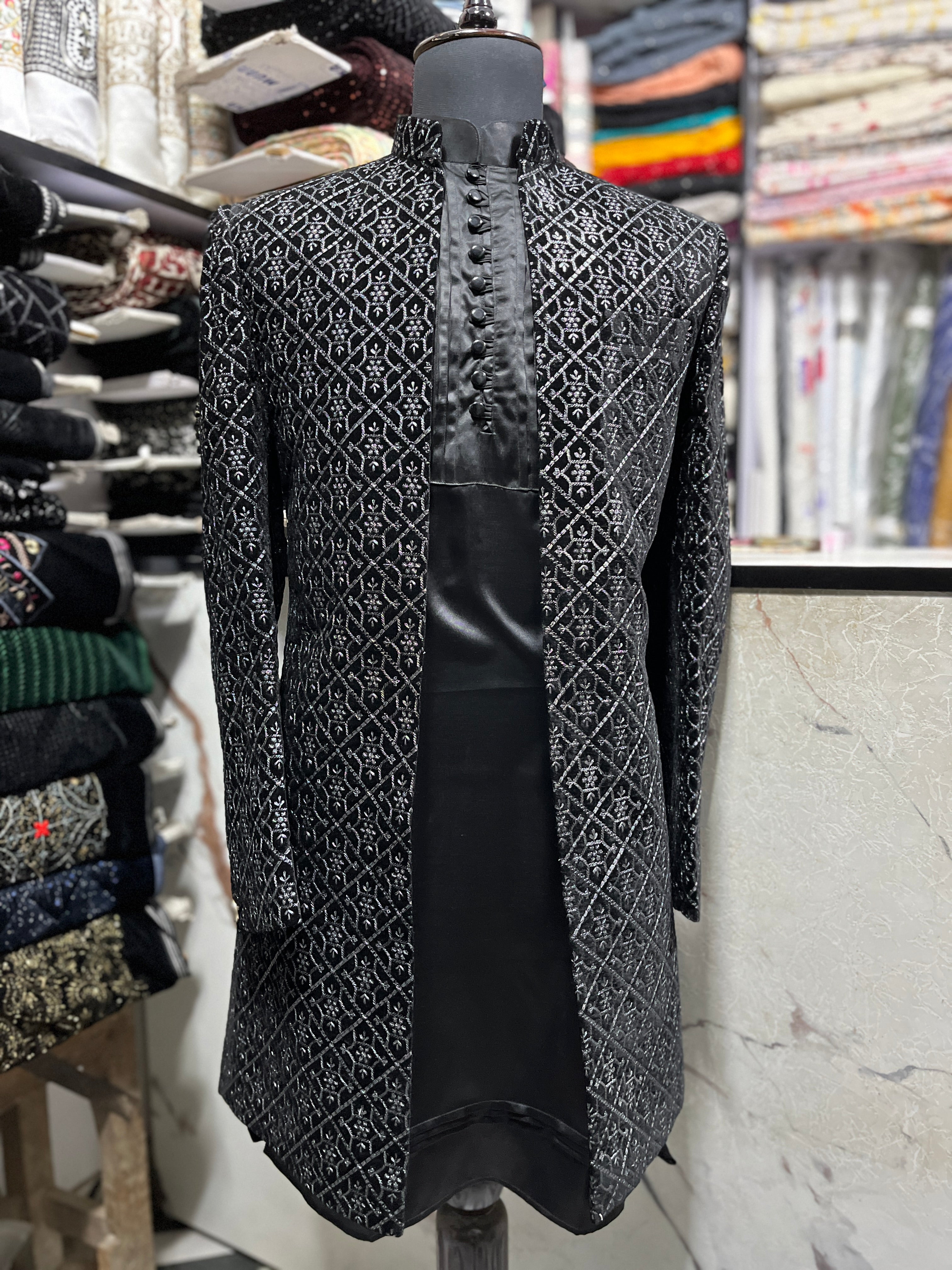 Full outfit showing the black kurta, trousers, and jacket ensemble
