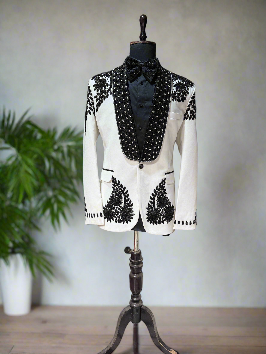 Groom's slim fit ivory tuxedo with peak lapel