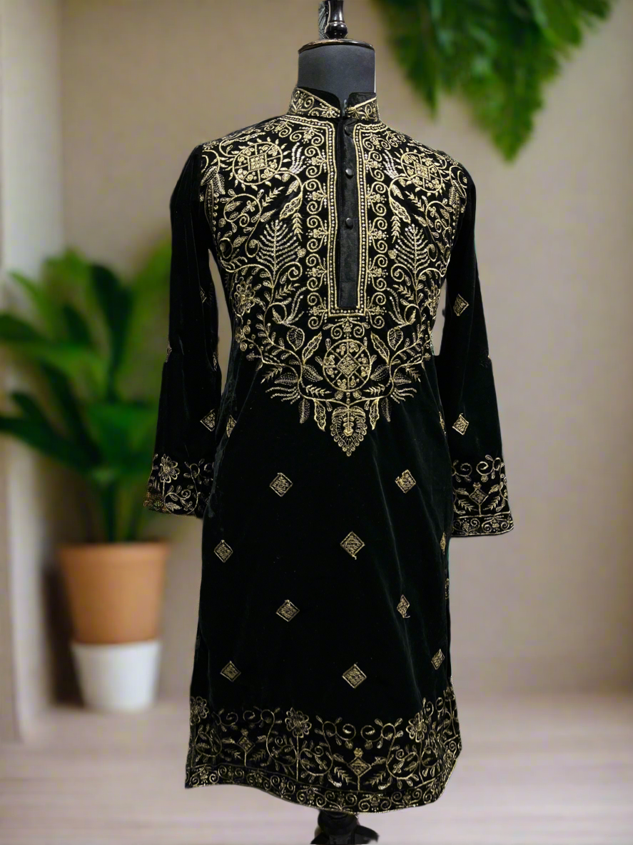 Close-up of golden embroidery on the black velvet kurta.