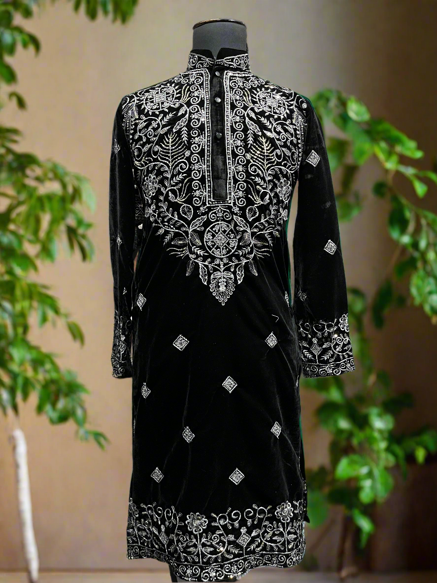 Men's black velvet kurta set with intricate silver embroidery.