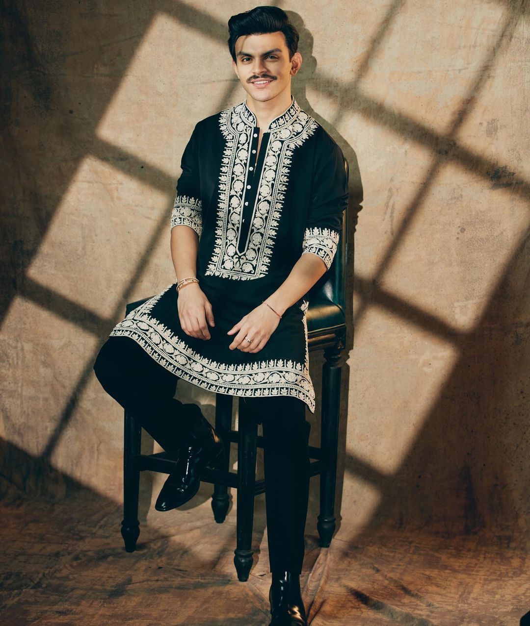 Men's handcrafted black velvet kurta set with tailored pants.